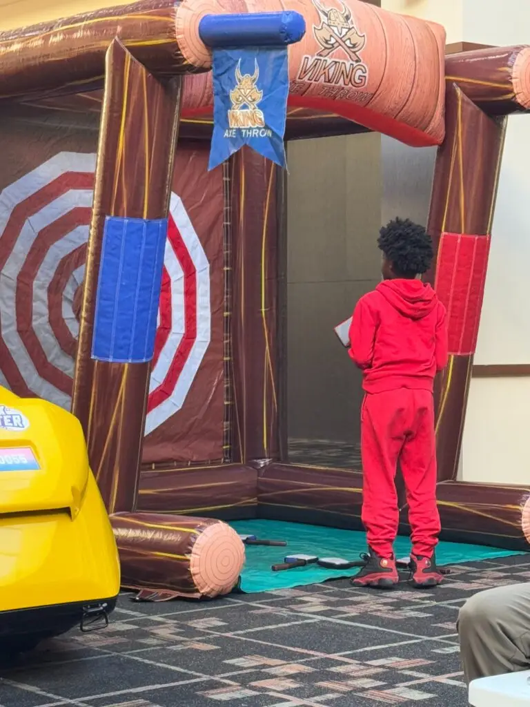 Child playing a Viking axe throw inflatable game at an event in Douglasville, Georgia provided by Marques Amusement Company