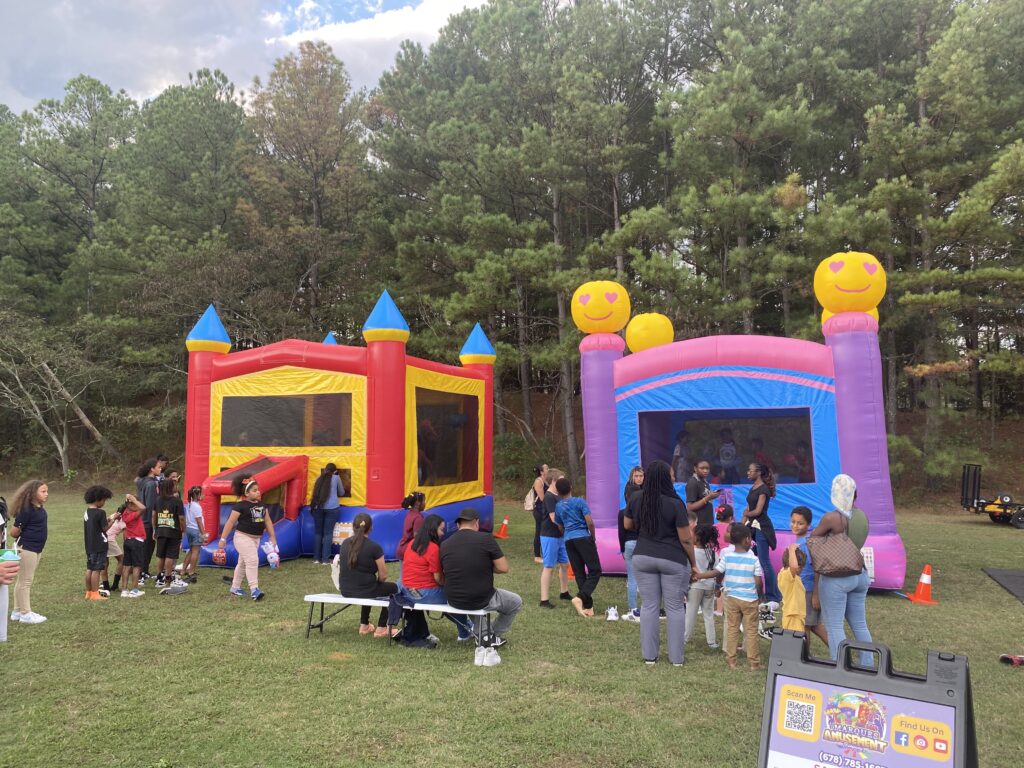 Kids enjoying bounce house rentals at a community event in College Park, GA provided by Marques Amusement Company