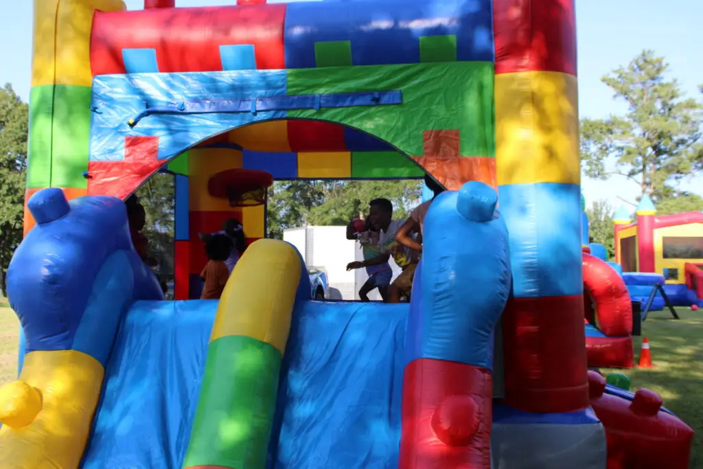 Kids playing inside a colorful bounce house at a party in Dallas GA provided by Marques Amusement Company