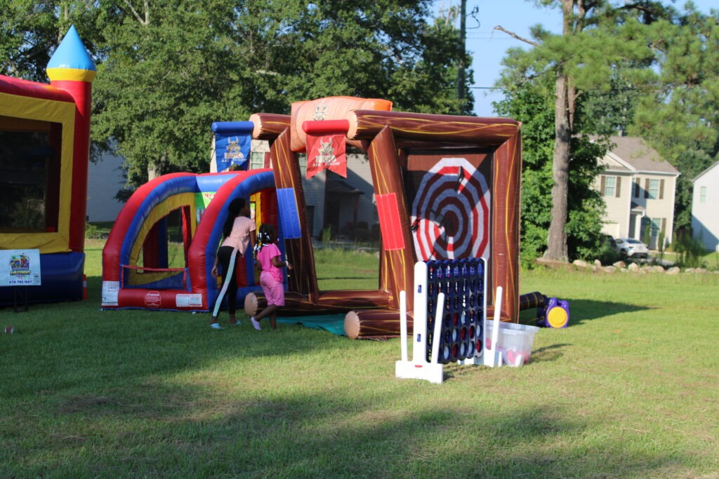 Kids playing interactive inflatable games at a Dallas GA party provided by Marques Amusement Company