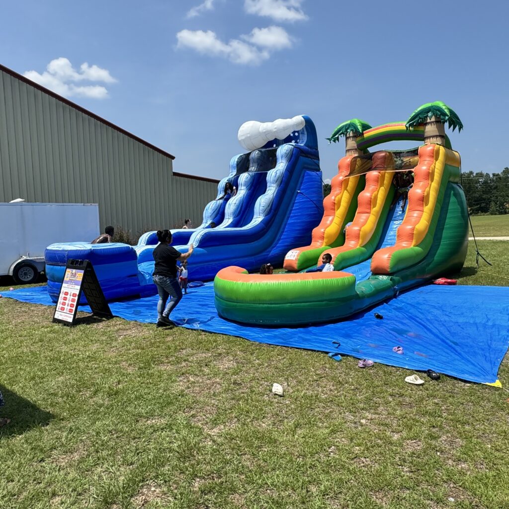 Two large inflatable water slide rentals set up for a summer event in Austell, Georgia