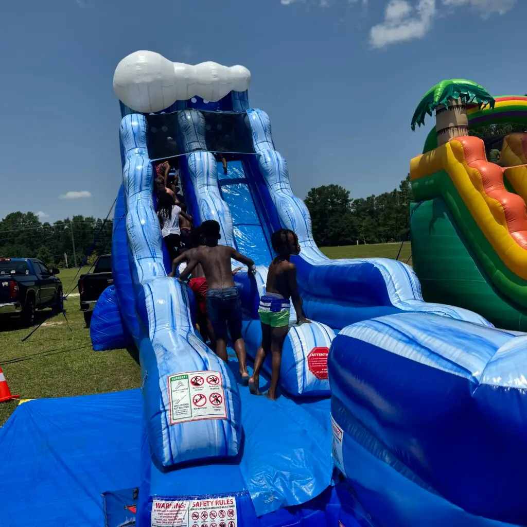 Kids climbing a large inflatable water slide for graduation parties in Atlanta, GA