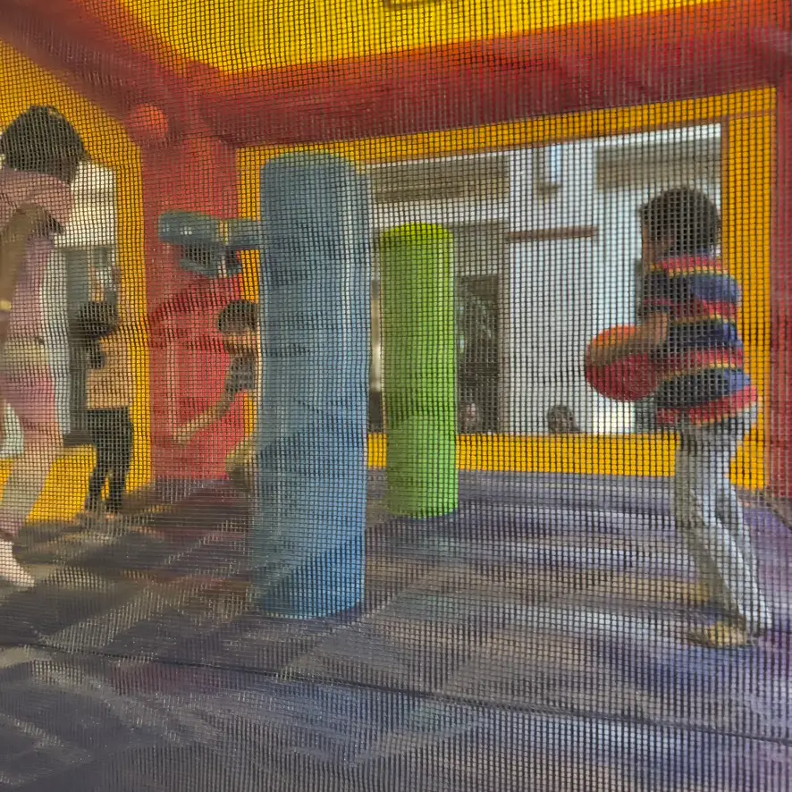 Kids playing inside a colorful bounce house rentals at a party in Atlanta, Georgia