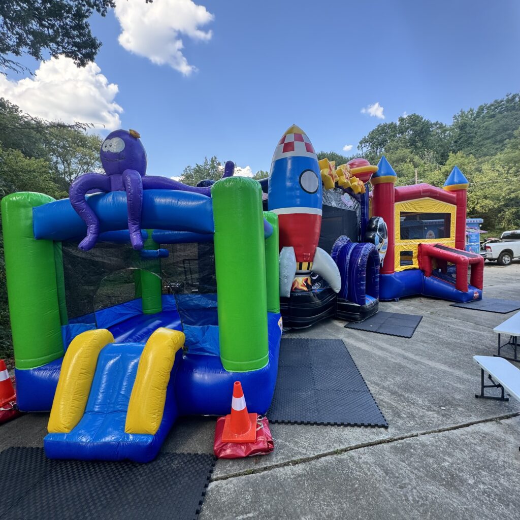 Multiple inflatable bounce houses and party rentals set up for an event in Lithia Springs GA by Marques Amusement Company
