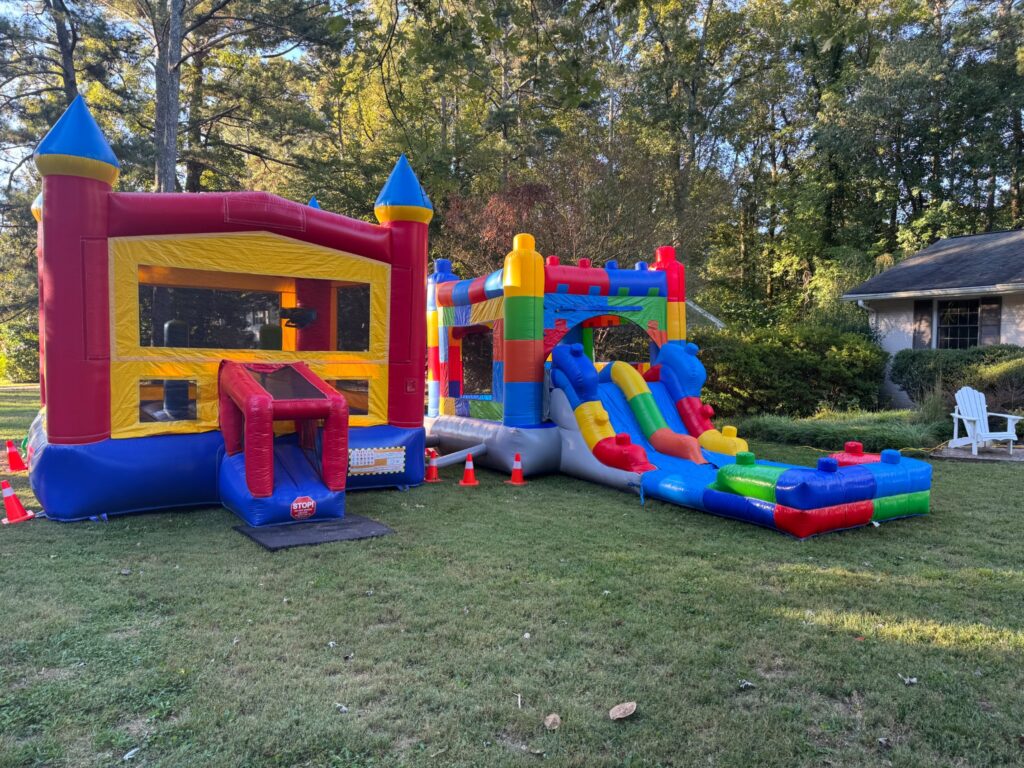 Bounce house and inflatable water slide set up together for a backyard party in Marietta, Georgia