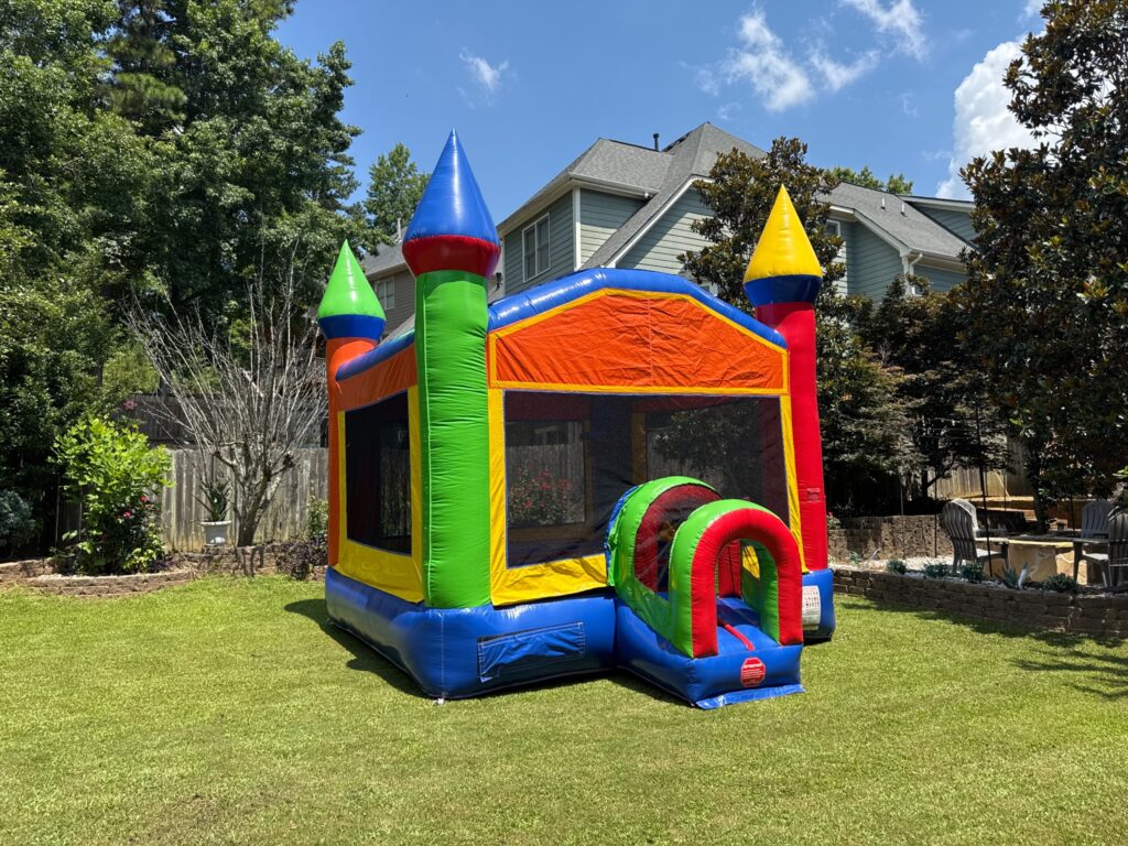 Colorful castle bounce house rentals with turrets set up in a Marietta, Georgia backyard for a party