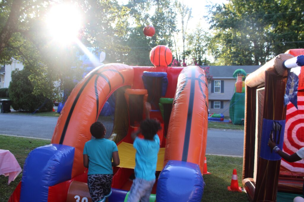 kids playing the Triple Threat Hoops inflatable basketball game at a Powder Springs GA party rental event