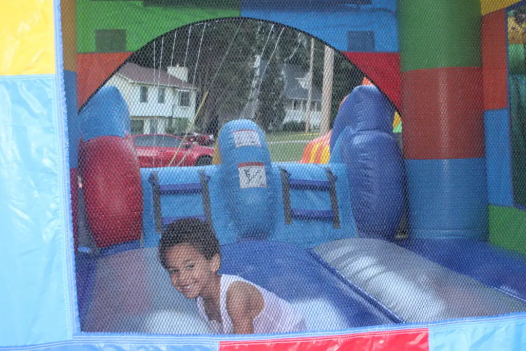 child playing inside a colorful bounce house at a Powder Springs GA party rental
