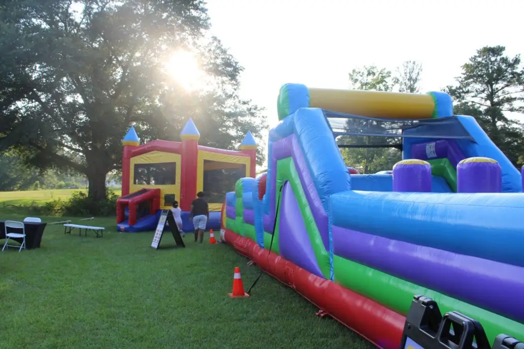 bounce houses and inflatable obstacle course set up for a Powder Springs GA outdoor event