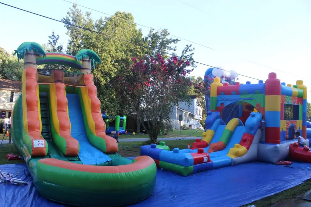 bounce houses rentals and water slides set up for a party in Powder Springs GA by Marques Amusement Company