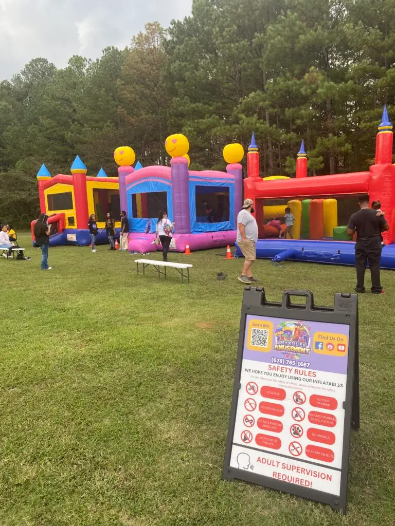Bounce house rentals in Riverdale, GA set up for a community event by Marques Amusement Company with multiple inflatables and party attractions