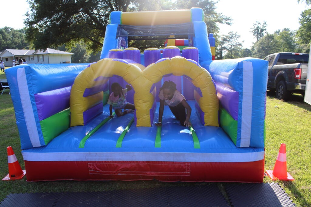 Kids playing on a colorful inflatable obstacle course at a Smyrna, Georgia event by Marques Amusement Company