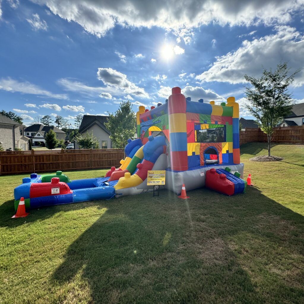 Large tropical bounce house rentals set up at a Smyrna, Georgia home for a party rental by Marques Amusement Company