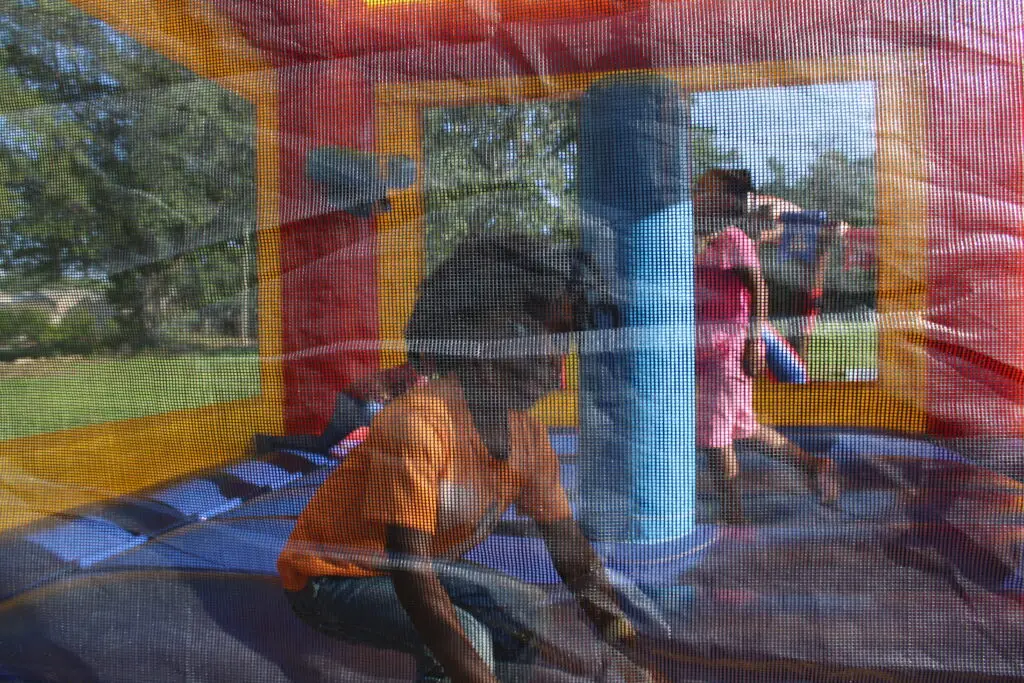 Kids playing inside a colorful bounce house at a Smyrna, Georgia party rental by Marques Amusement Company