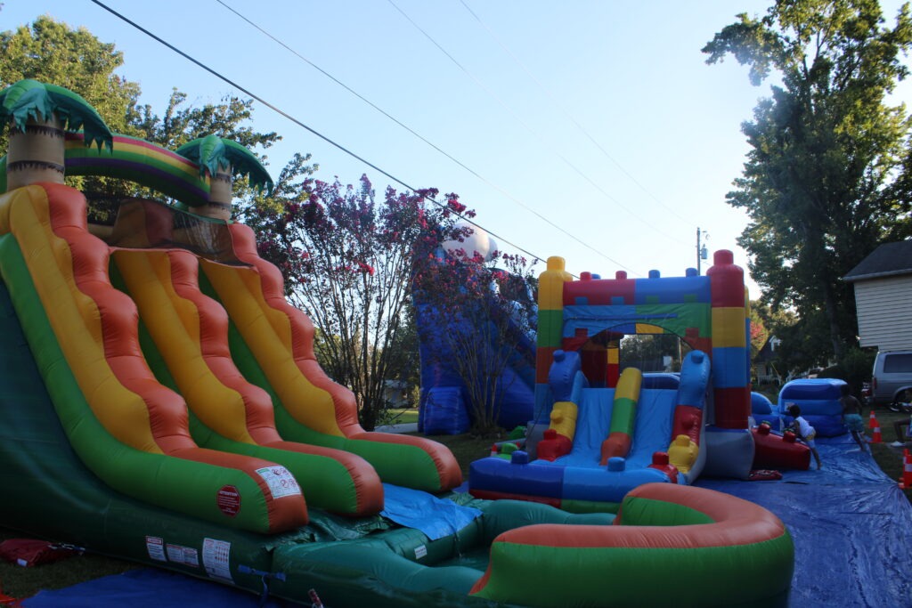 Bounce house and inflatable water slide rentals set up for a neighborhood event in Austell, Georgia