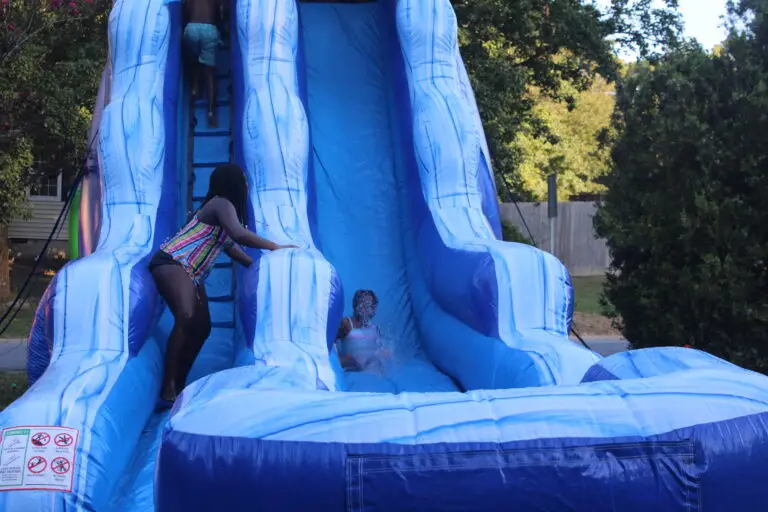 Kids enjoying water slide rentals at a backyard party in Atlanta, Georgia