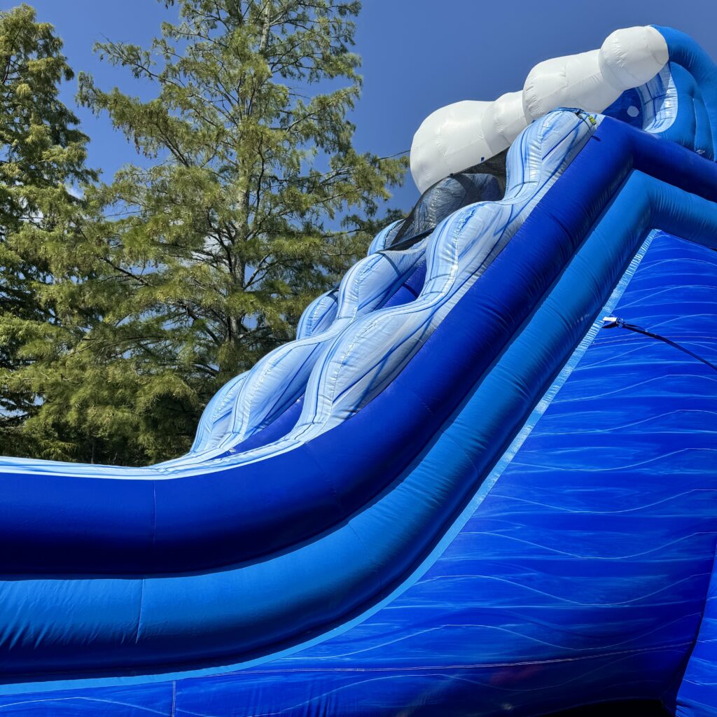 Large inflatable water slide rental set up for an outdoor event in Austell, Georgia