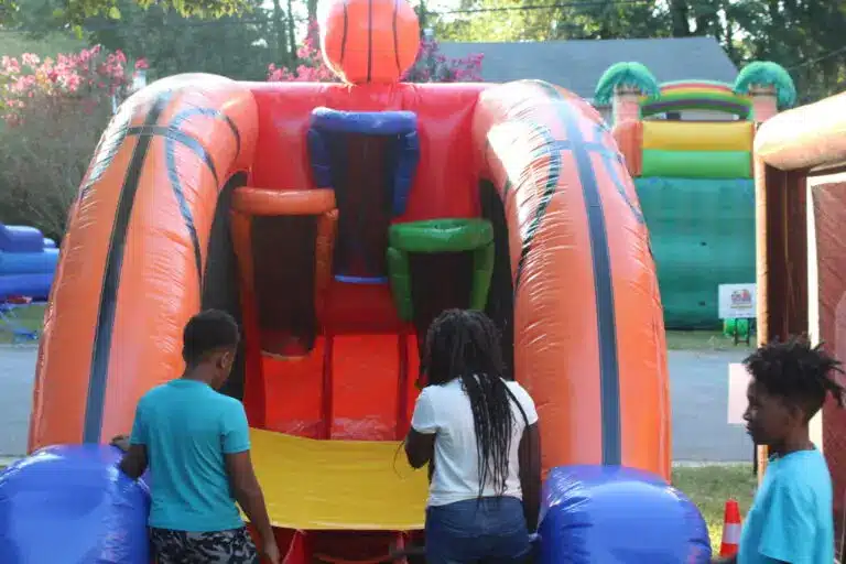Kids playing an inflatable basketball game at a spring event rentals in Atlanta